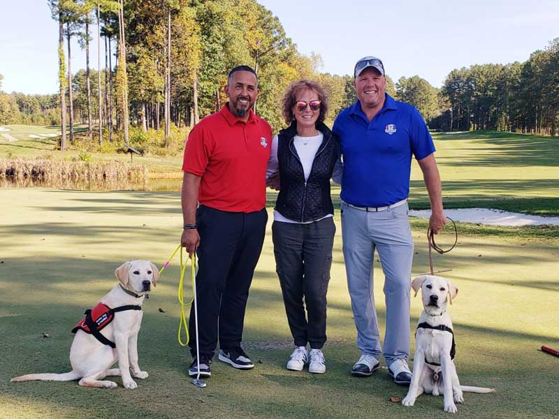Valor Cup golfers and dogs