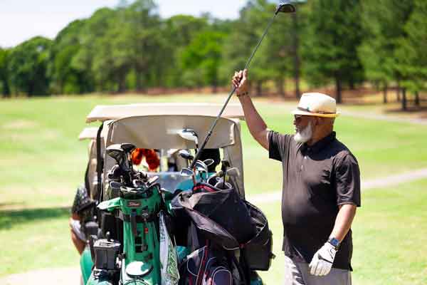 2026 Fairways to Freedom Golf Tournament - golfer placing his putter back in to his golf bag on course