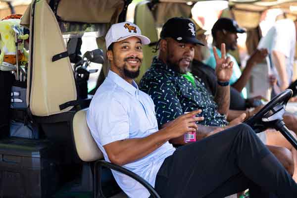 2026 Fairways to Freedom Golf Tournament - golfers in golf cart saying "hi"